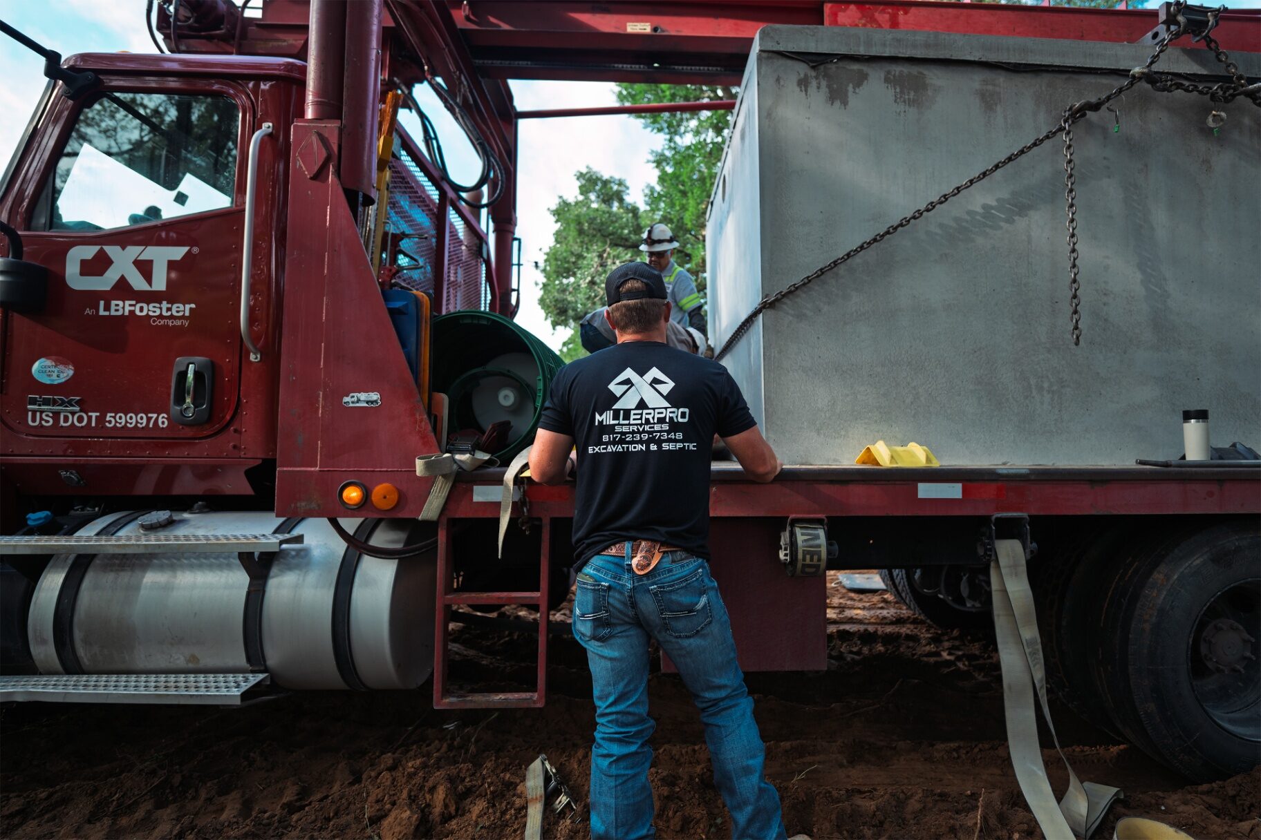Crew setting a concrete septic tank near Grandview, Texas